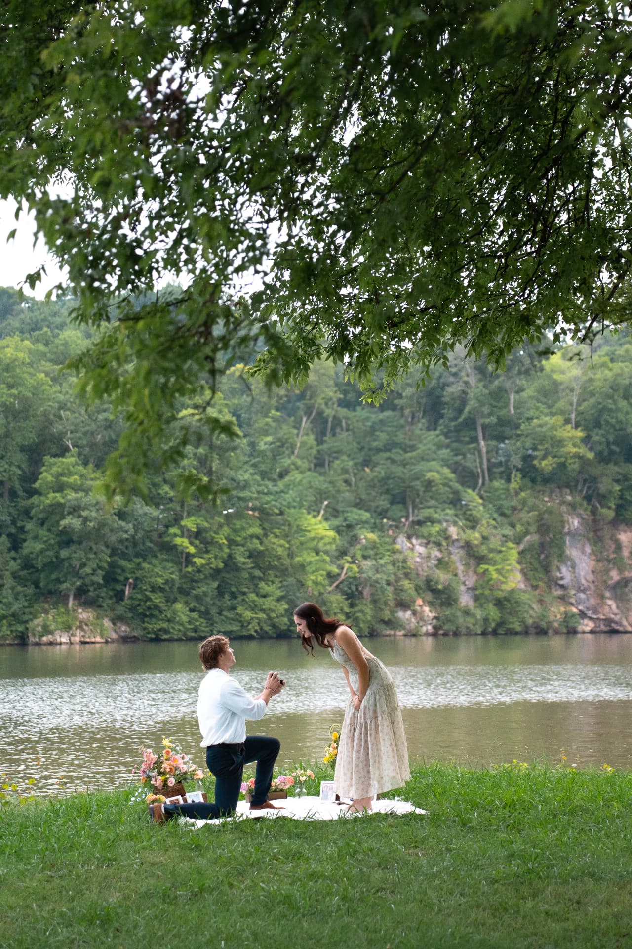 The proposal by the river with flowers nearby