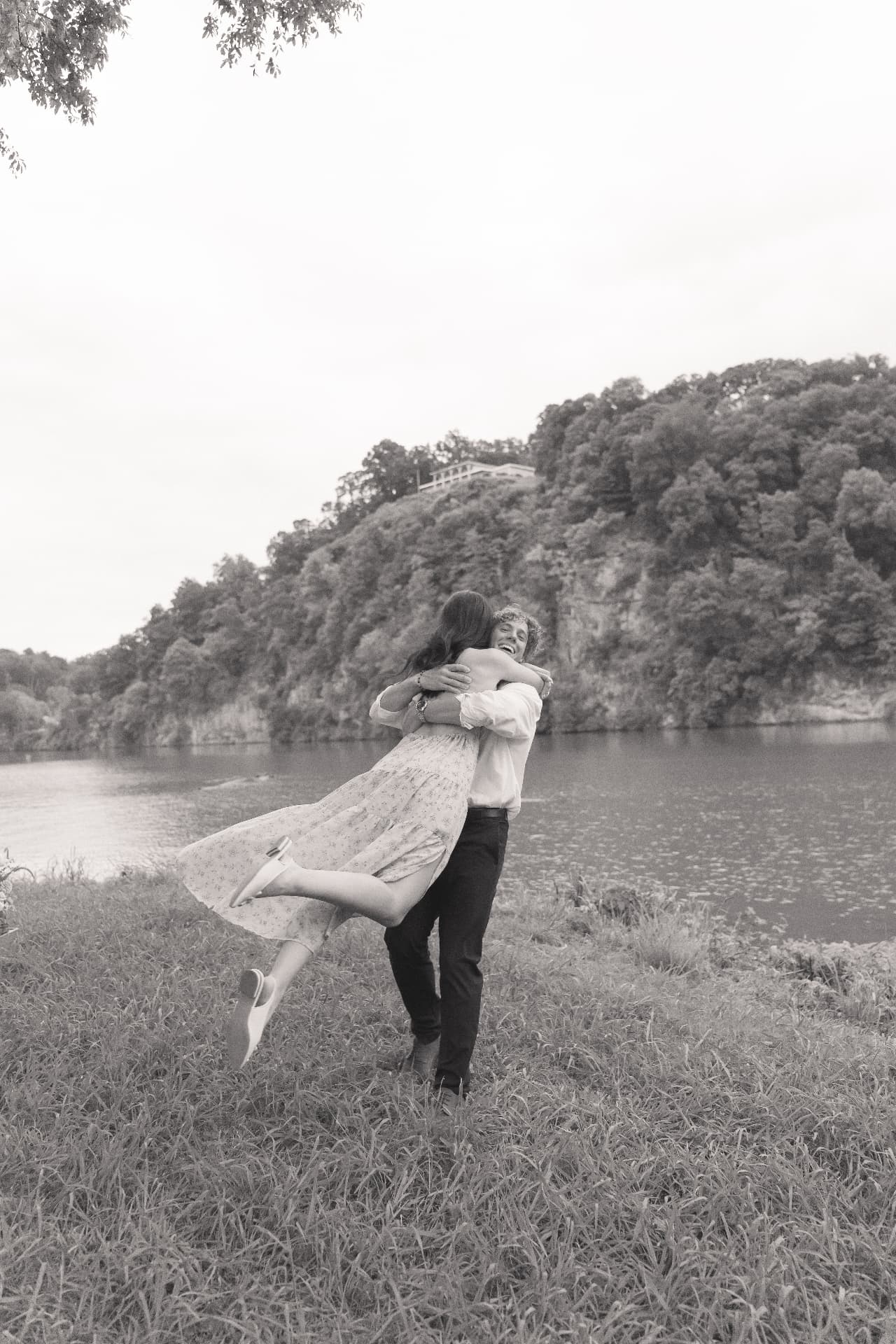 Zachary lifting Simoné in a hug by the water