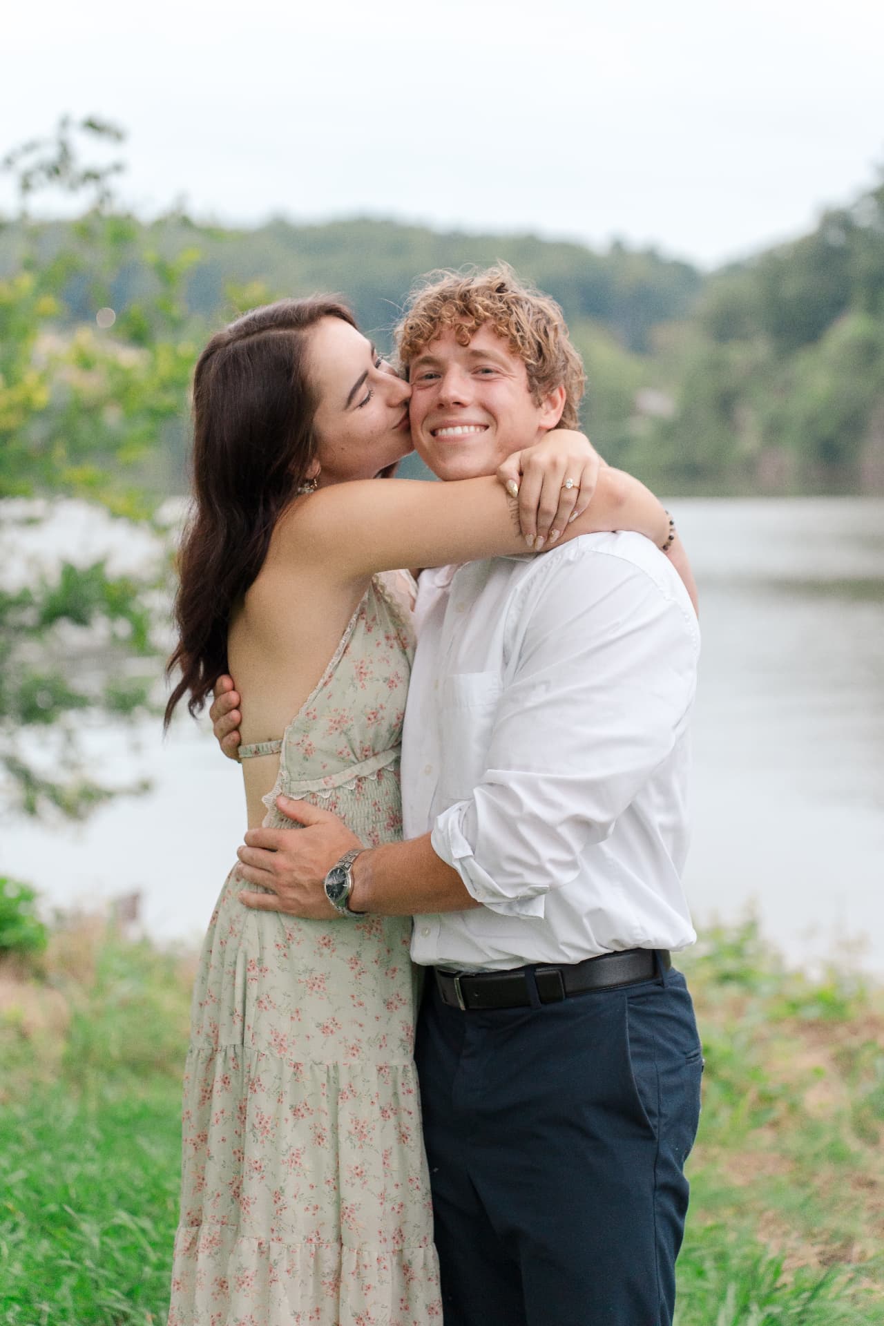 Simoné kissing Zachary on the cheek by the lake